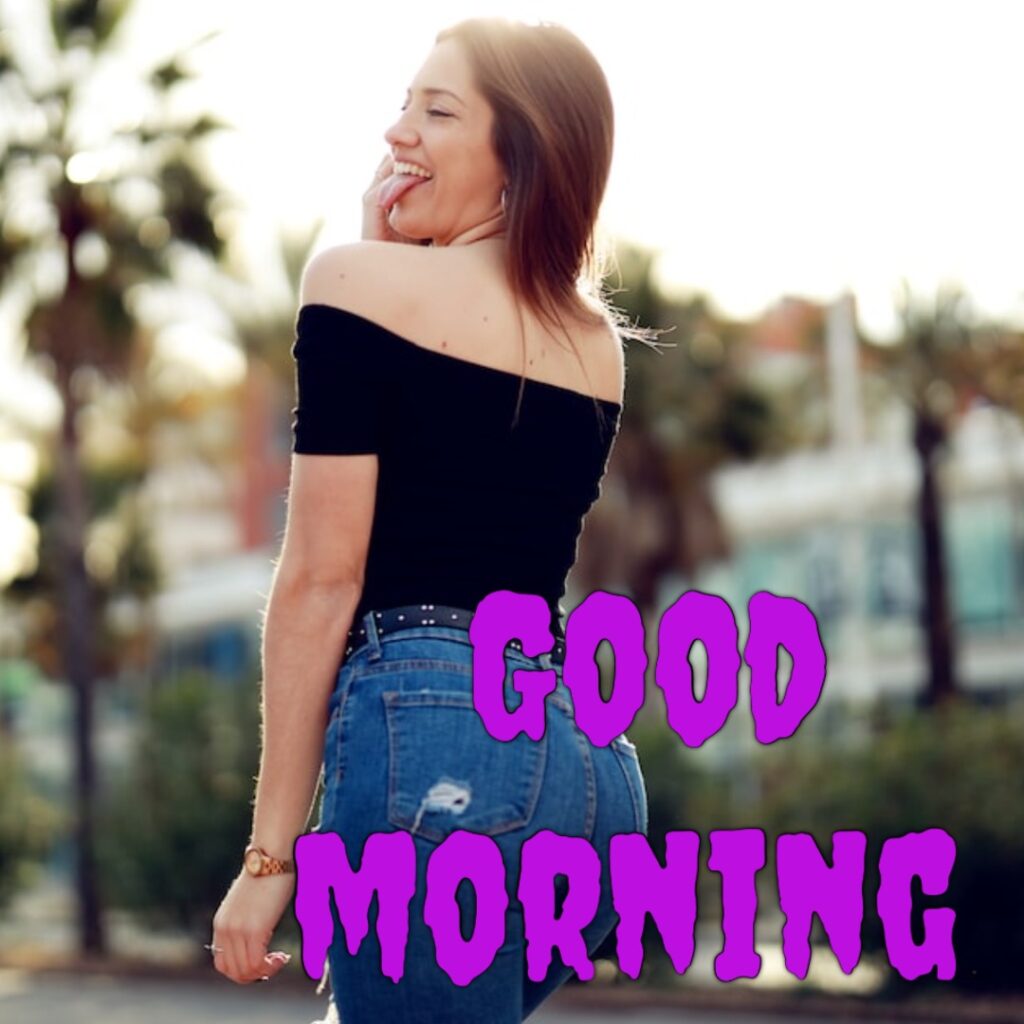 A very hot funny girl having blue jeans and Balck half t shirt looking like a funny good morning image